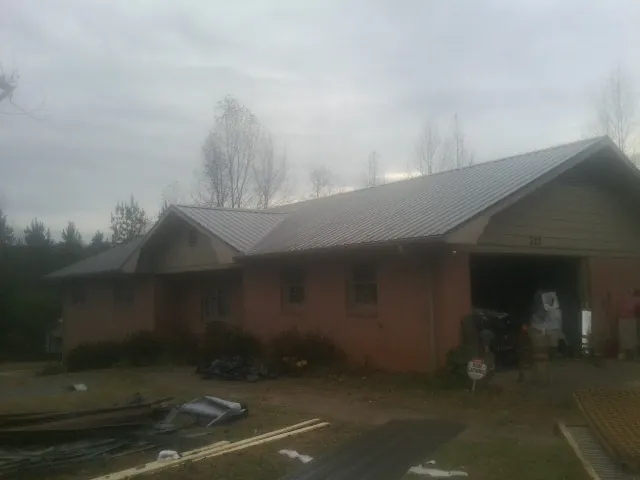 Gray metal roof on a stucco house with an attached garage in Campbell