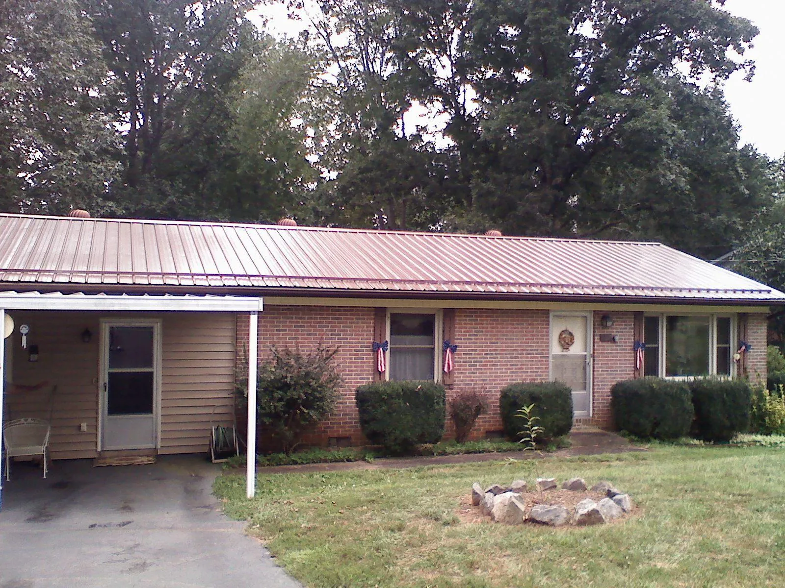 Bronze metal roof and carport on a brick ranch home — Roof Repair work by our crew in Campbell
